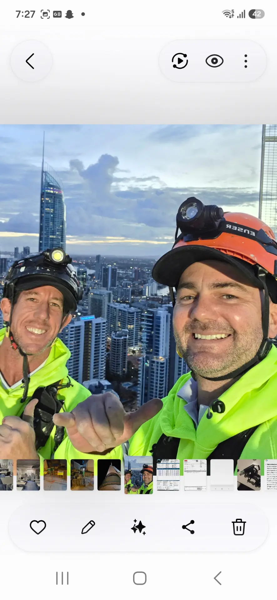 Rope access technician on a high rise glass facade