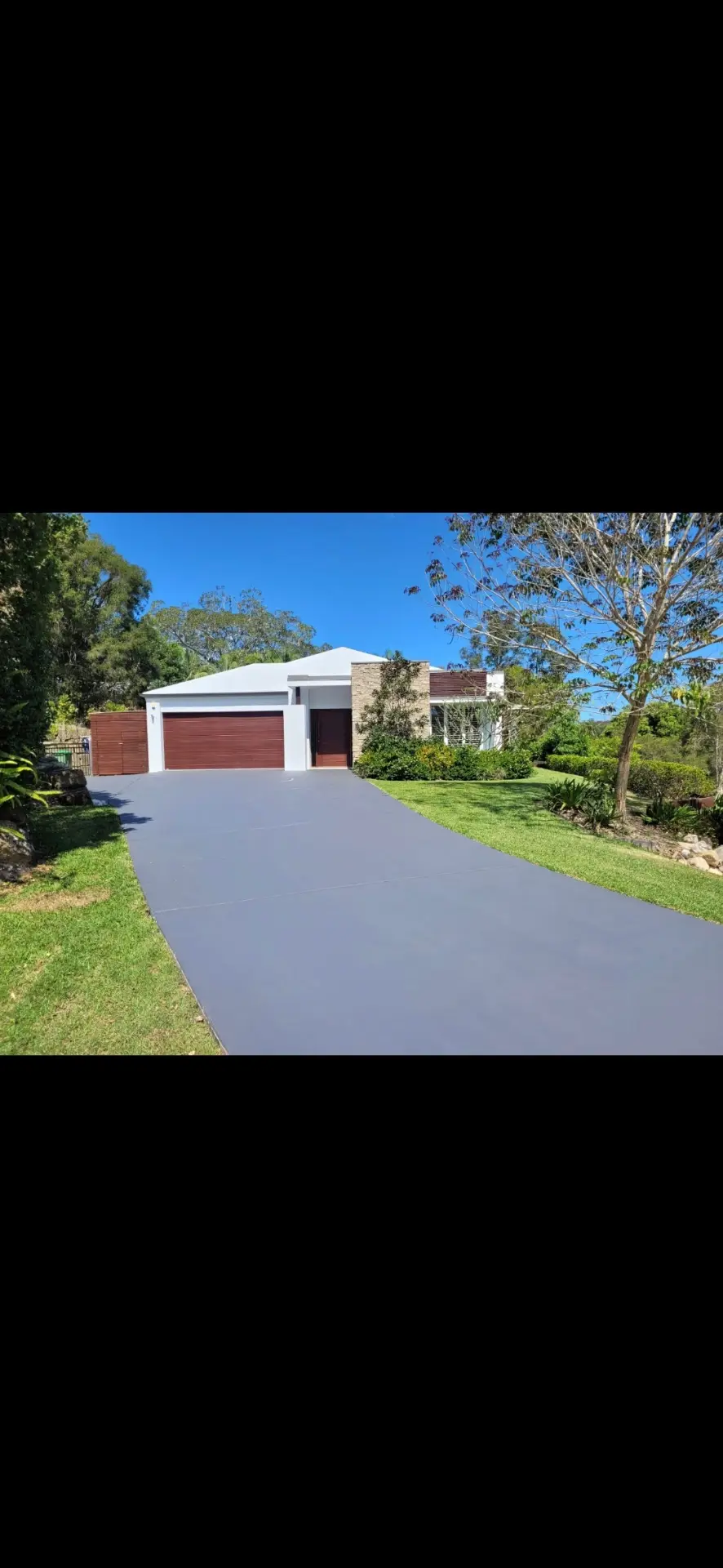 Resurfaced residential driveway with smooth grey finish