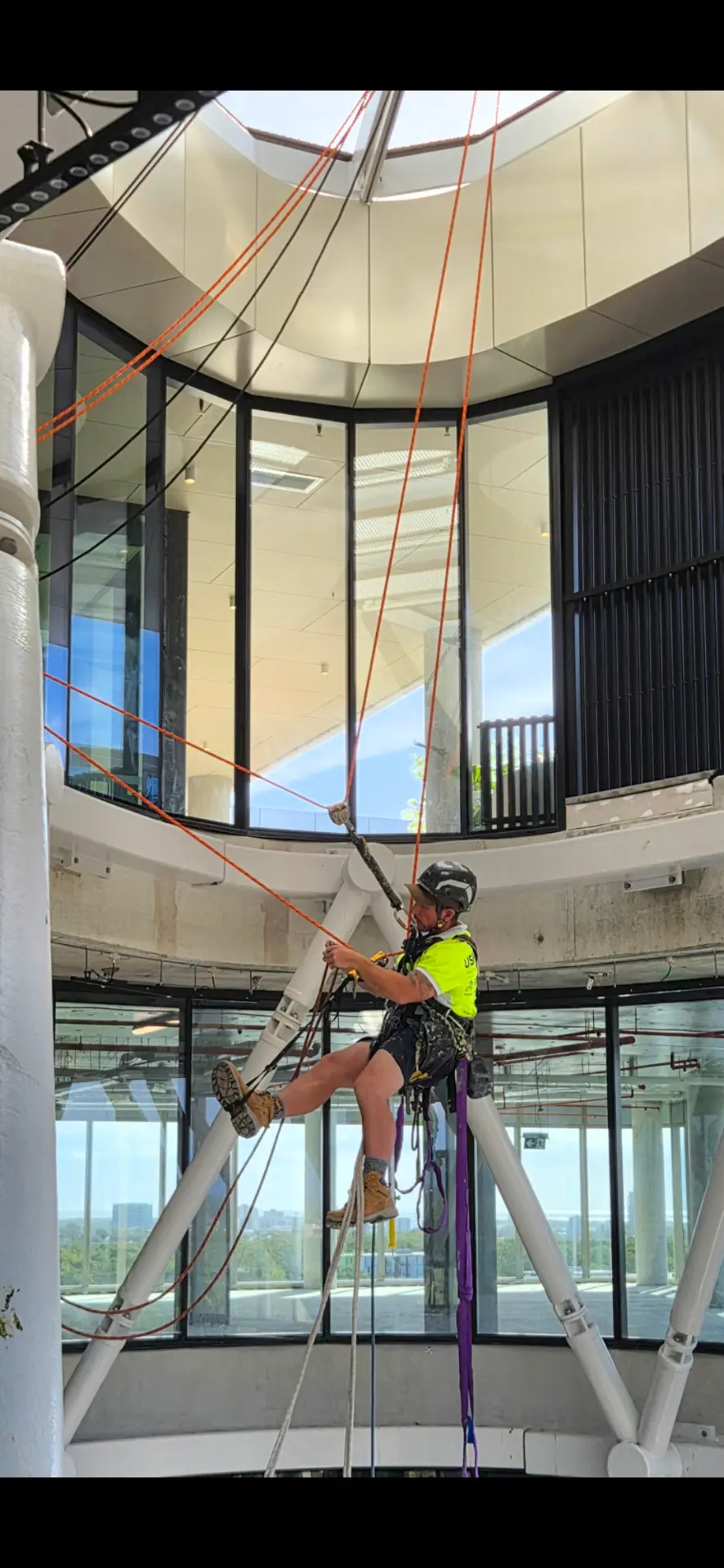 Rope access technician working inside an atrium
